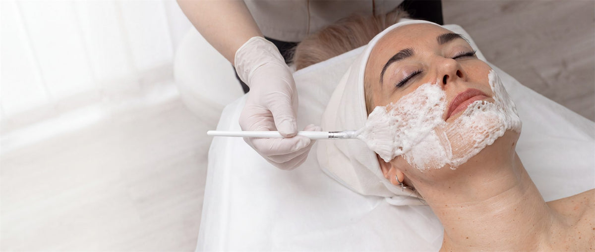 Applying the carboxy mask to the face with a brush in the treatment room