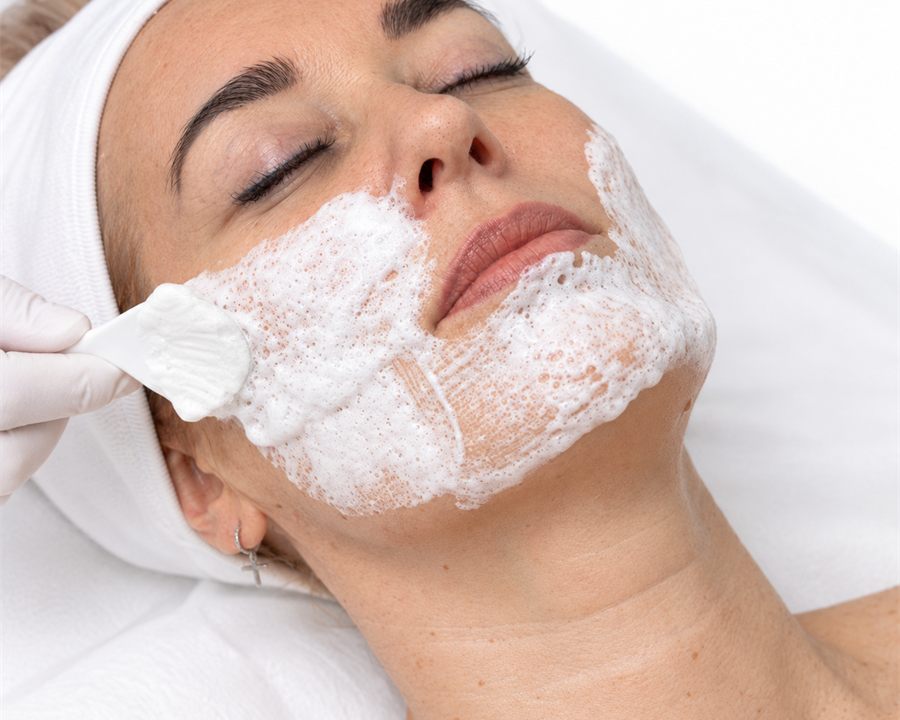 Applying the carboxy mask to facial skin with a brush
